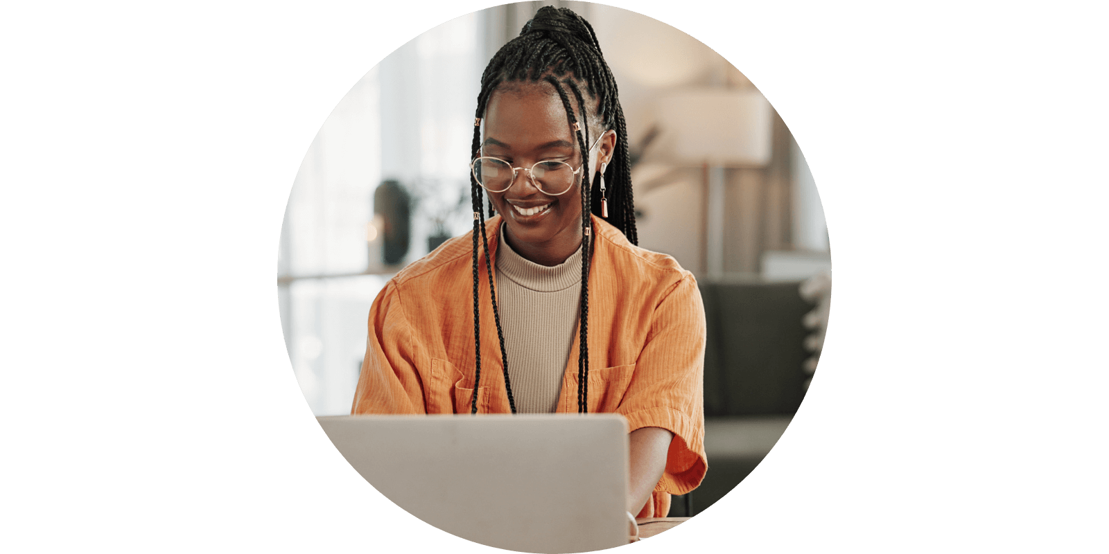 Smiling person looking at a laptop