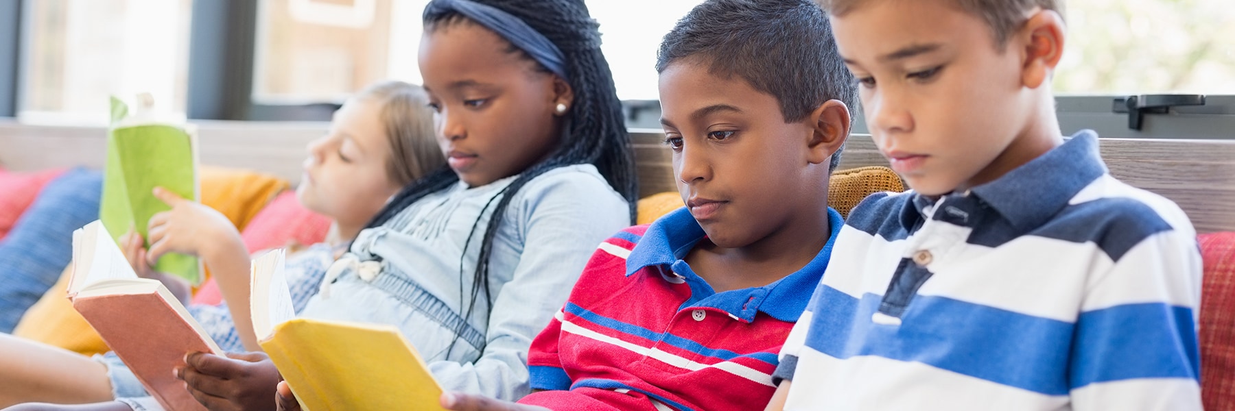 Four students reading independently