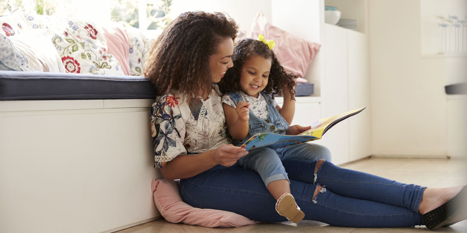 Mother reading to her daughter.