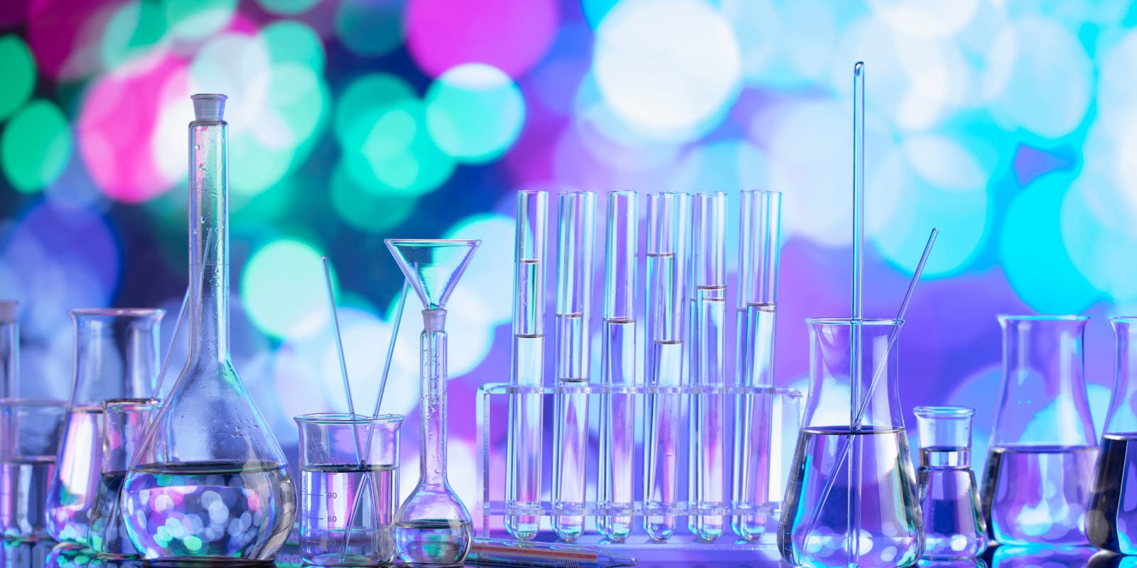 Various glass laboratory equipment arranged on a table