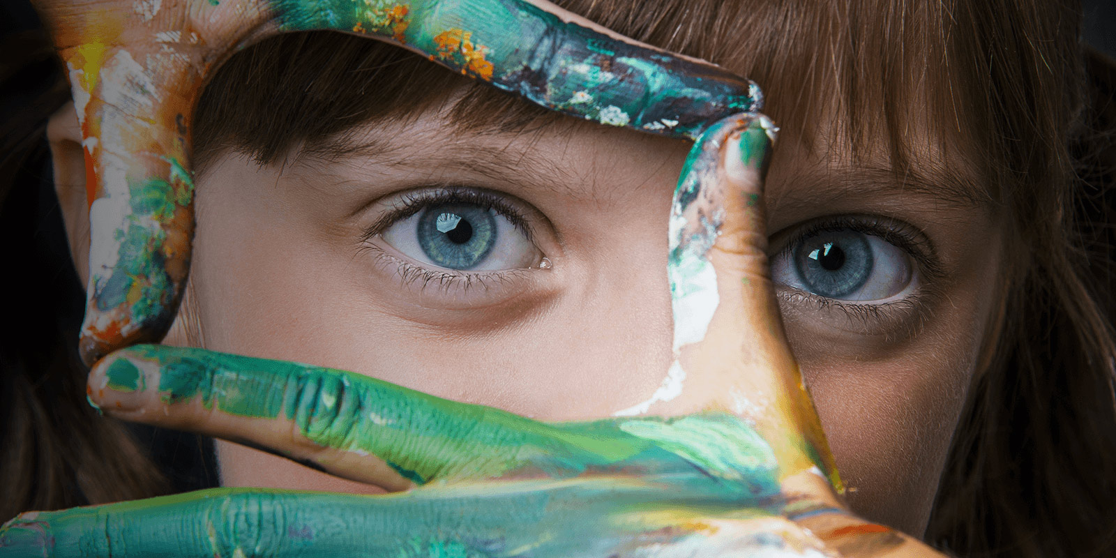 child with paint on their hands