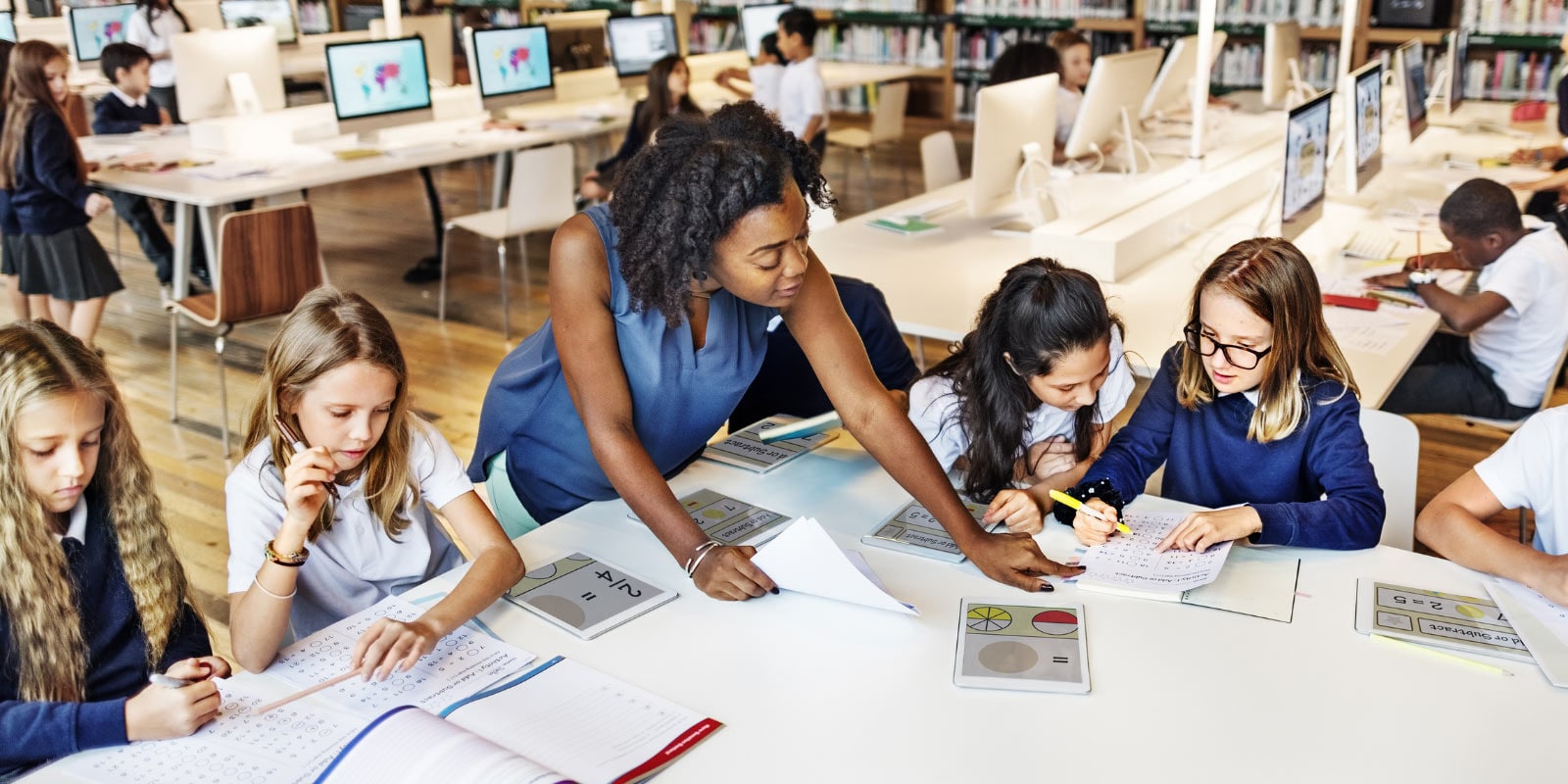 Teacher helping students with class work