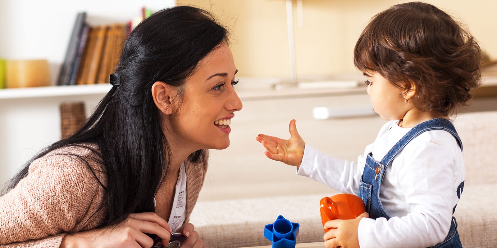 Female teacher working with a young child. 